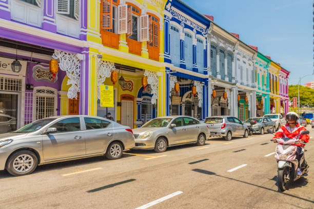 George Town, Penang Island Malaysia. March 8 2019. A street scene with people in George Town Malaysia. George Town is the colorful, multicultural capital of the Malaysian island of Penang. The city is known for its British colonial buildings, Chinese shophouses and mosques.